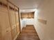 Functional laundry room with modern appliances, cabinetry, and wood-look flooring at 971 S Evanston Cir, Aurora, CO 80012