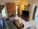 Bright living room featuring a brick fireplace and an inviting open entrance at 971 S Evanston Cir, Aurora, CO 80012