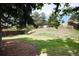 Large, grassy backyard with mature trees and partial fencing at 9837 E Aberdeen Ave, Englewood, CO 80111