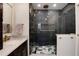 Modern bathroom featuring a walk-in shower with blue tile and gold fixtures, a luxurious and stylish space at 9837 E Aberdeen Ave, Englewood, CO 80111
