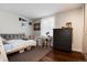Cozy bedroom boasts a comfortable twin bed, a wooden floor, and a bright window at 9837 E Aberdeen Ave, Englewood, CO 80111