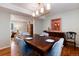 Elegant dining room with wood floors, stylish light fixture, and dining table with seating at 9837 E Aberdeen Ave, Englewood, CO 80111