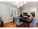 Elegant dining room with a wood table set for dinner and bright natural light at 9837 E Aberdeen Ave, Englewood, CO 80111