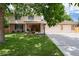 Inviting two-story home featuring a brick facade, three-car garage and mature trees at 9837 E Aberdeen Ave, Englewood, CO 80111
