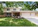 Charming two-story brick home with a three-car garage and well-manicured lawn at 9837 E Aberdeen Ave, Englewood, CO 80111