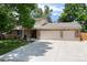 Charming brick and siding home with a three car garage and a wide driveway at 9837 E Aberdeen Ave, Englewood, CO 80111