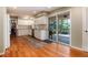 Bright kitchen featuring granite countertops, white cabinets, and wood floors leading to the patio at 9837 E Aberdeen Ave, Englewood, CO 80111