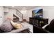 Cozy living room with comfortable seating, a large screen TV, and a staircase at 9837 E Aberdeen Ave, Englewood, CO 80111