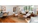 Cozy living room featuring hardwood floors, abundant natural light, and stylish furnishings at 9837 E Aberdeen Ave, Englewood, CO 80111