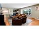 Comfortable living room with hardwood floors, a large window, and stylish furniture, adjacent to the kitchen at 9837 E Aberdeen Ave, Englewood, CO 80111