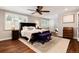 Serene main bedroom with a ceiling fan, plenty of natural light, and hardwood floors, offering a relaxing retreat at 9837 E Aberdeen Ave, Englewood, CO 80111