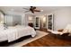 Spacious main bedroom with hardwood floors and access to the Primary bathroom through glass paneled french doors at 9837 E Aberdeen Ave, Englewood, CO 80111