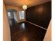 Formal dining room featuring hardwood floors, dark accent wall, classic chandelier, and plenty of natural light at 3231 Lump Gulch Way, Erie, CO 80516