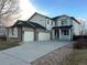 Charming two-story home featuring a three-car garage, covered porch, and professional landscaping at 3231 Lump Gulch Way, Erie, CO 80516