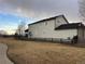 Expansive side yard features a rustic fence surrounding the charming two-story home with neutral siding at 3231 Lump Gulch Way, Erie, CO 80516