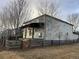 Backyard view of a house with a covered patio and a wooden fence, creating a private outdoor space at 3231 Lump Gulch Way, Erie, CO 80516