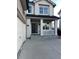 Inviting covered front porch featuring white columns and railings, perfect for enjoying the outdoors at 3231 Lump Gulch Way, Erie, CO 80516