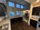 Bright living area viewed from the kitchen, featuring a fireplace and ample natural light at 3231 Lump Gulch Way, Erie, CO 80516