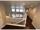 Bright foyer boasts hardwood floors, white railing staircase, and a view of the living area below at 3231 Lump Gulch Way, Erie, CO 80516