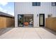 Rear view of the property showing backyard patio, privacy fence and sliding glass door at 1571 Vrain St, Denver, CO 80204
