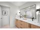 Luxury bathroom showcasing dual vanities, a large mirror, and modern lighting fixtures at 1571 Vrain St, Denver, CO 80204