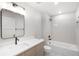 Modern bathroom features a sleek vanity, large mirror, and shower over tub at 1571 Vrain St, Denver, CO 80204