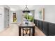 Bright dining room with a dark wood table, modern chairs, pendant lighting, and elegant wall decor at 1571 Vrain St, Denver, CO 80204