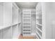 Organized walk-in closet featuring custom shelving, hanging rods, and ample storage space at 1571 Vrain St, Denver, CO 80204