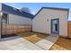 Enclosed backyard area with a concrete patio, small patch of grass, and a blue door to the home at 3725 N Franklin St, Denver, CO 80205