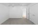 Unfinished basement area with carpet and white walls leading to the utility room at 3725 N Franklin St, Denver, CO 80205