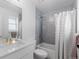 Bright bathroom with modern fixtures, gray tiling, and a shower-tub combination at 3725 N Franklin St, Denver, CO 80205