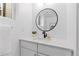 Bright bathroom featuring a modern vanity with sleek countertop and a contemporary round mirror at 3725 N Franklin St, Denver, CO 80205