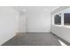 A minimalist bedroom featuring neutral carpet, white walls, and a bright window providing natural light at 3725 N Franklin St, Denver, CO 80205