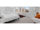 Bright bedroom with white walls, three windows, and a comfortable seating area at 3725 N Franklin St, Denver, CO 80205