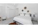 Airy bedroom with a bed, sliding closet doors, neutral decor, and a cowhide-patterned rug at 3725 N Franklin St, Denver, CO 80205