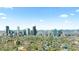 Stunning city view featuring modern skyscrapers, lush greenery, and distant mountain range on the horizon at 3725 N Franklin St, Denver, CO 80205