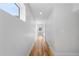 Bright hallway with hardwood floors and ample natural light streaming through the window at the end at 3725 N Franklin St, Denver, CO 80205