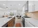 Modern kitchen with stainless appliances, island with bar seating, and open layout at 3725 N Franklin St, Denver, CO 80205