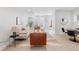Well-lit living room featuring stylish seating, a modern rug, and a view into the dining area at 3725 N Franklin St, Denver, CO 80205