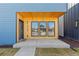 Inviting porch with wood accents, three windows, and a blue door enhancing the exterior charm at 3725 N Franklin St, Denver, CO 80205