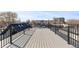 Spacious rooftop deck with gray decking and black metal railings offering city views at 3725 N Franklin St, Denver, CO 80205