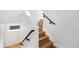 Bright staircase featuring light wood treads, white risers, and a modern black handrail at 3725 N Franklin St, Denver, CO 80205
