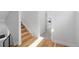 Modern stairway featuring wood steps, black metal railings, and plenty of natural light, next to an open doorway at 3725 N Franklin St, Denver, CO 80205