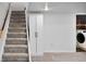 Basement stairs leading down to a closet and laundry machines at 6353 W 78Th Ave, Arvada, CO 80003