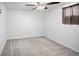 Cozy bedroom featuring neutral carpet, a ceiling fan, and a window with a curtain at 6353 W 78Th Ave, Arvada, CO 80003