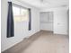 Bright bedroom featuring a ceiling fan, a window with gray curtains, and a closet with shelving at 6353 W 78Th Ave, Arvada, CO 80003