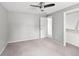 Bedroom featuring gray walls, carpeted floors, ceiling fan, and closet with shelving at 6353 W 78Th Ave, Arvada, CO 80003