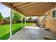 View of the home's covered patio and a large lawn area at 6353 W 78Th Ave, Arvada, CO 80003