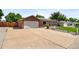 Charming single story home with long driveway, attached garage, and well-manicured lawn at 6353 W 78Th Ave, Arvada, CO 80003