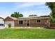 A well-kept single-story home with solar panels, an attached garage, and lush front yard at 6353 W 78Th Ave, Arvada, CO 80003
